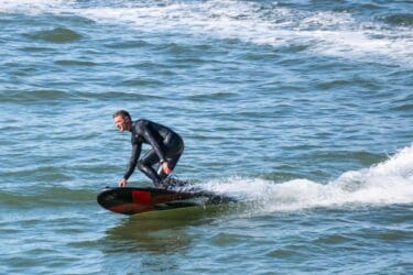 Onean Carver X JetBoard 16 Onean Carver X Electric Jetboard with guy in a wet suit 1 scaled 1